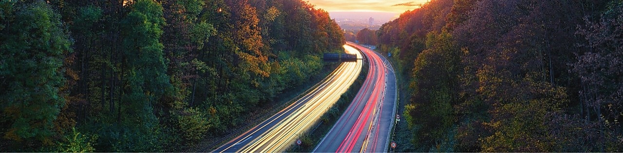 Light trails traffic, mountain road at dusk