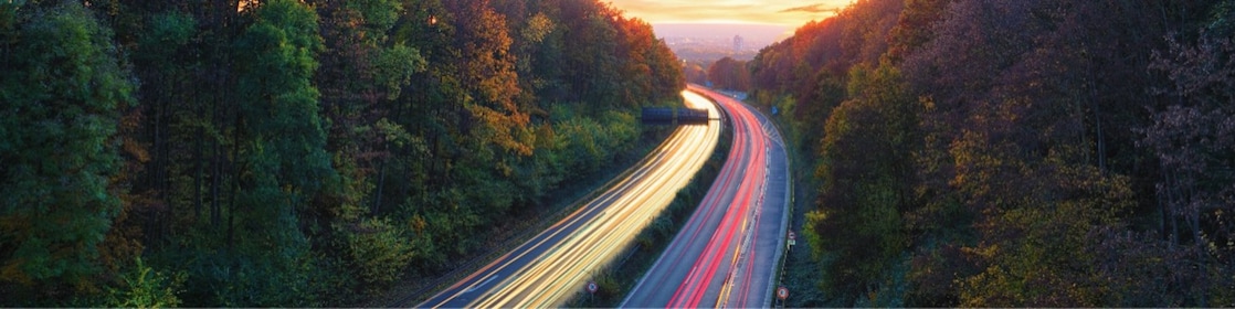 Light trails traffic, mountain road at dusk