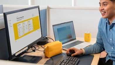 Manager on an office desk using a desktop computer