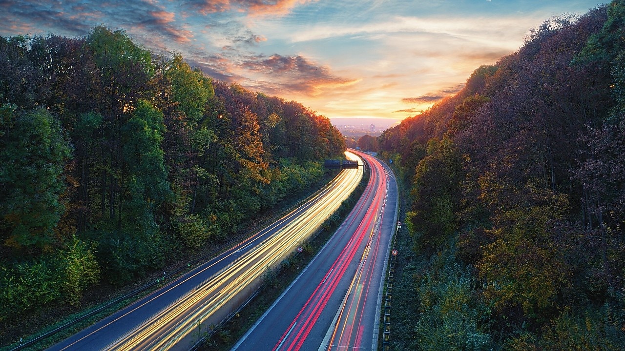 Light trails traffic, mountain road at dusk