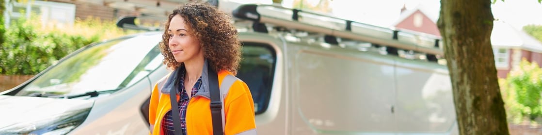 Engineer standing next to fleet minivan