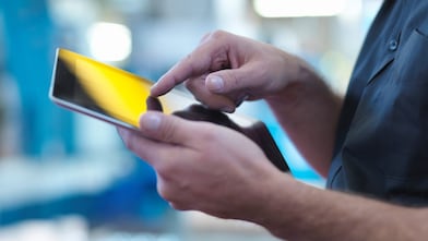 A manager tapping on a tablet