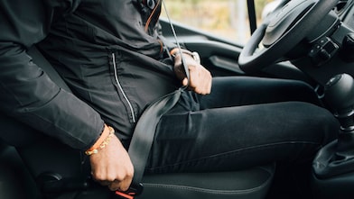 Man Fastening Seat Belt