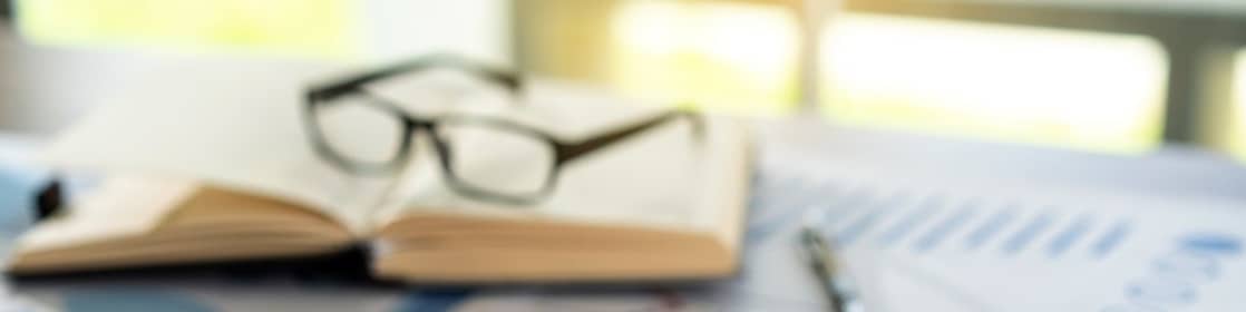image of stationery & glasses on desk