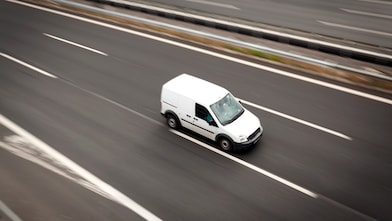 Delivery white van moving highway road