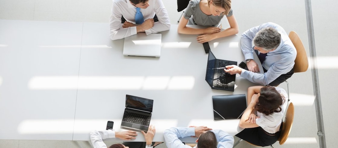 Employees meeting on a boardroom table