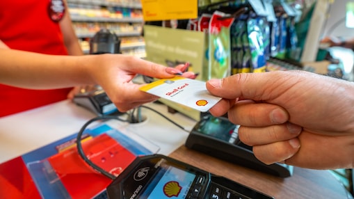 Shell Card handed over from one person to clerk at gas station