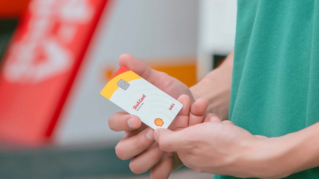 Driver near Shell gas station holding card