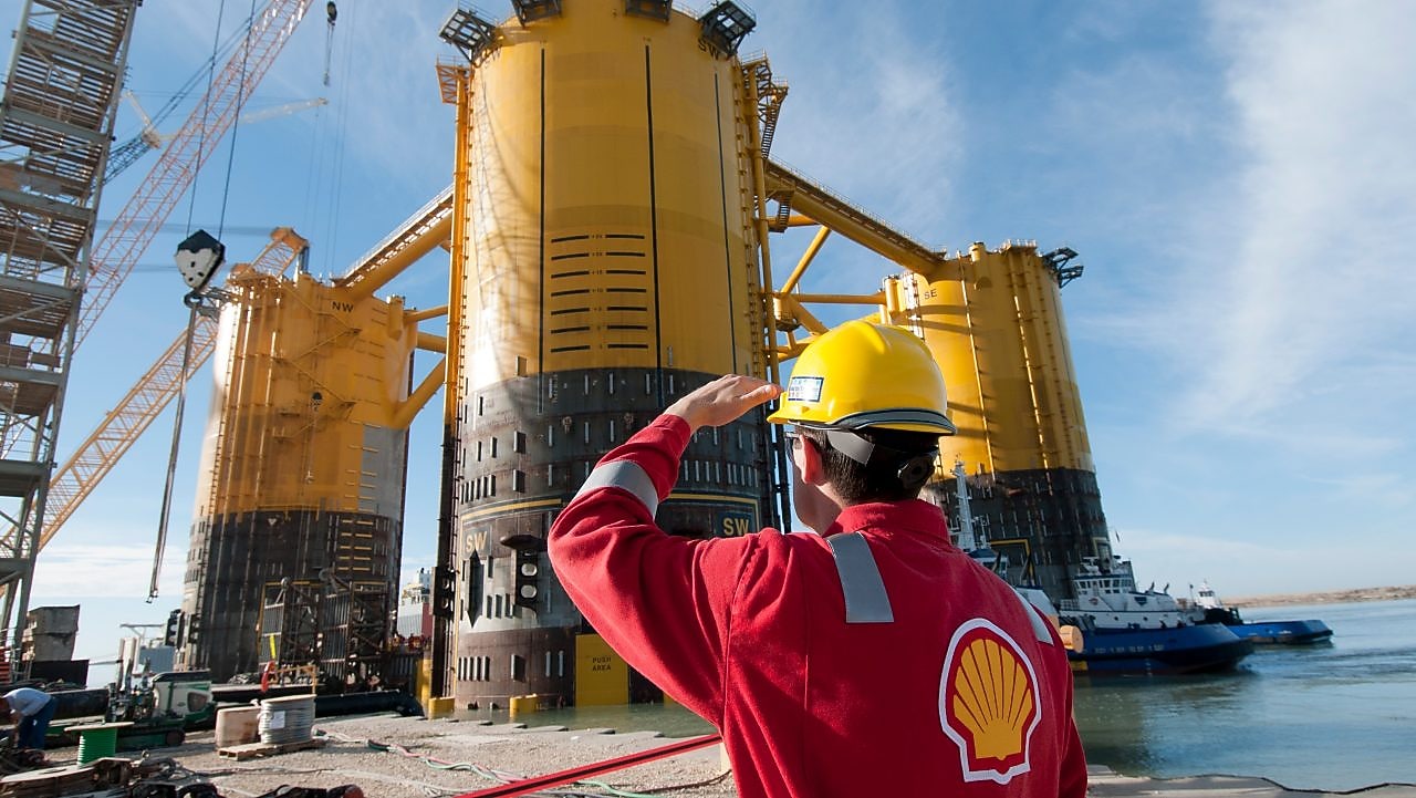 A Shell worker inspects the Olympus hull