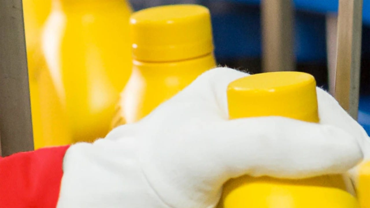 Hand grabbing plastic bottle