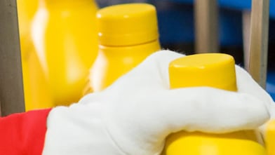 Hand grabbing plastic bottle