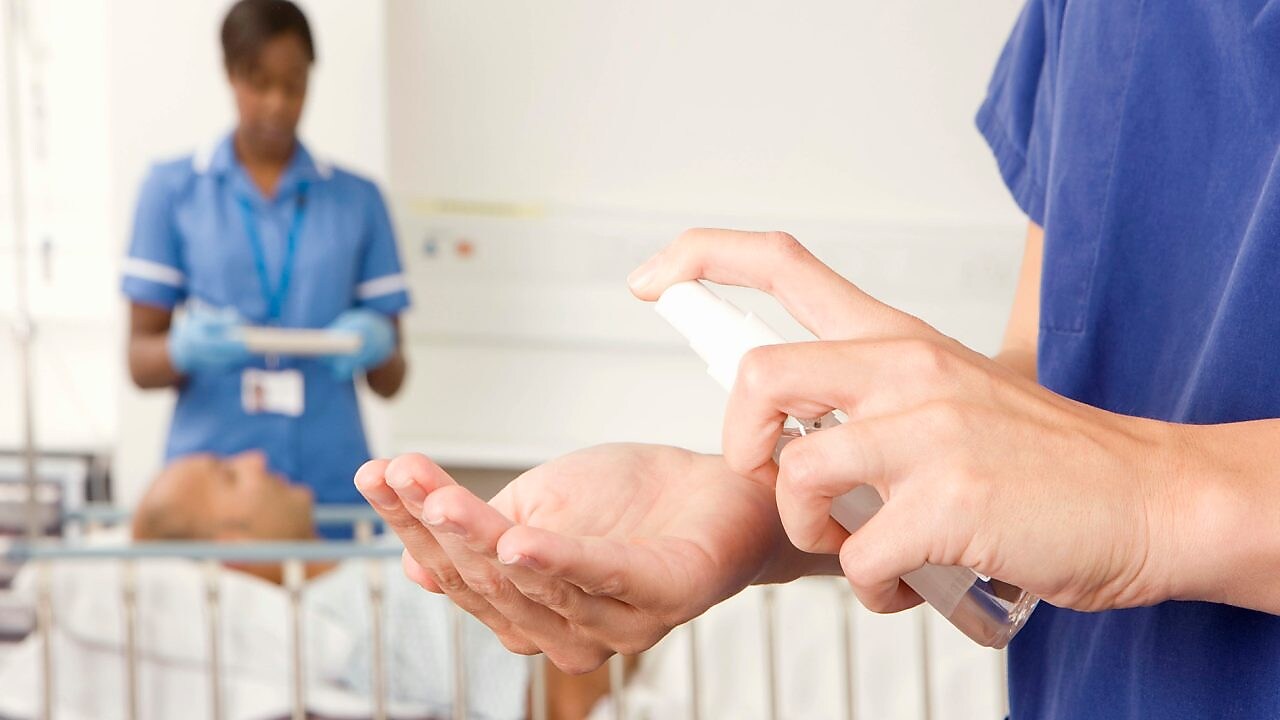 Hand holding sanitizer