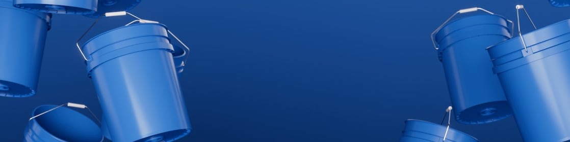 Black 5-gallon buckets in an industrial setting