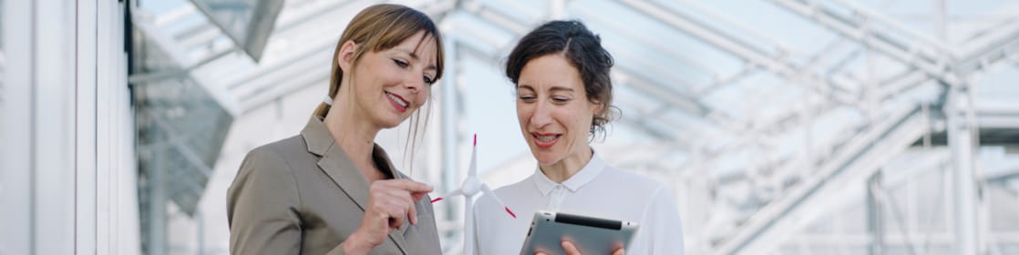 Two women discussing business in an airy setting