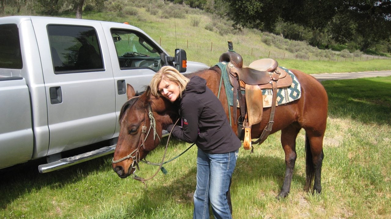 Kim with a horse on a vacation.