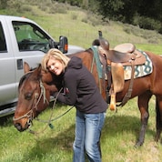 Kim with a horse on a vacation.