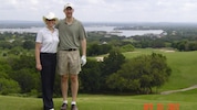 Kim with her husband on a golf course