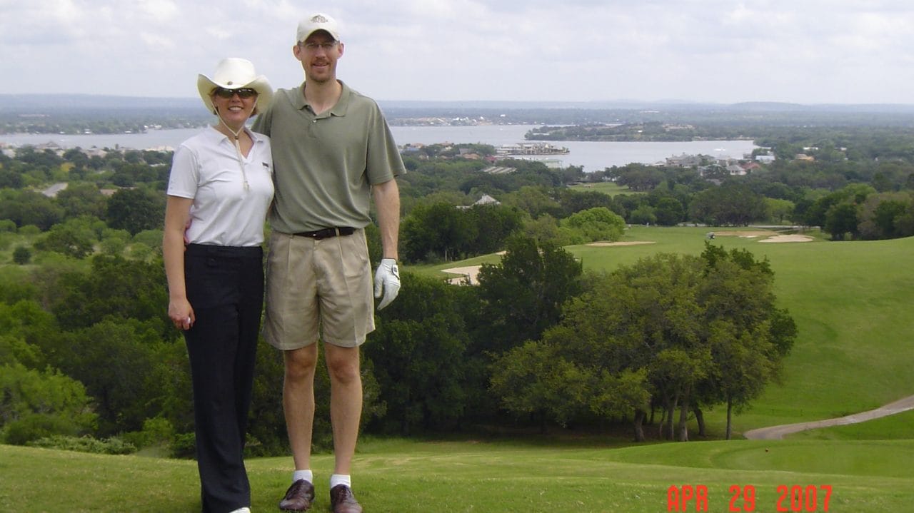 Kim with her husband on a golf course