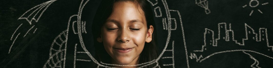 Young girl dreaming of her future as an astronaut.
