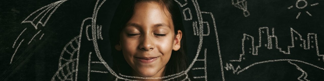 Young girl dreaming of her future as an astronaut.
