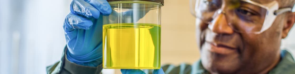 Scientist holding yellow solution