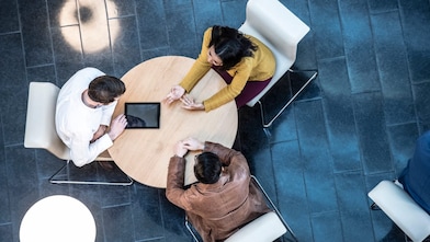 Team of Polymer Experts talking around a table