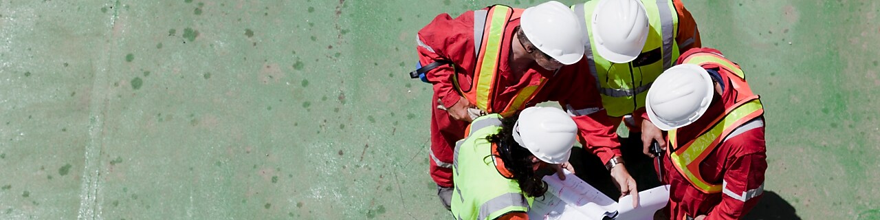 Workers in hard hats strategizing on the jobsite