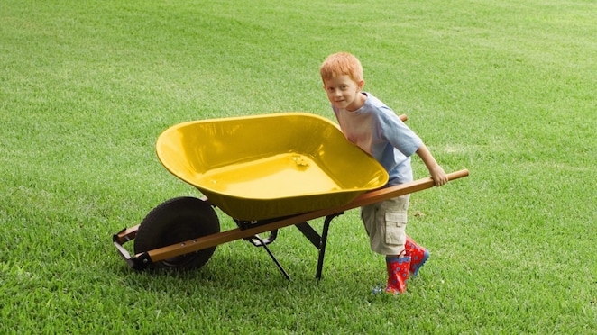 A child walking on blades of artificial grass, which are an HDPE plastic product
