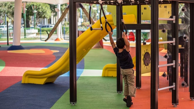 Child playing on an LLDPE plastic playground set