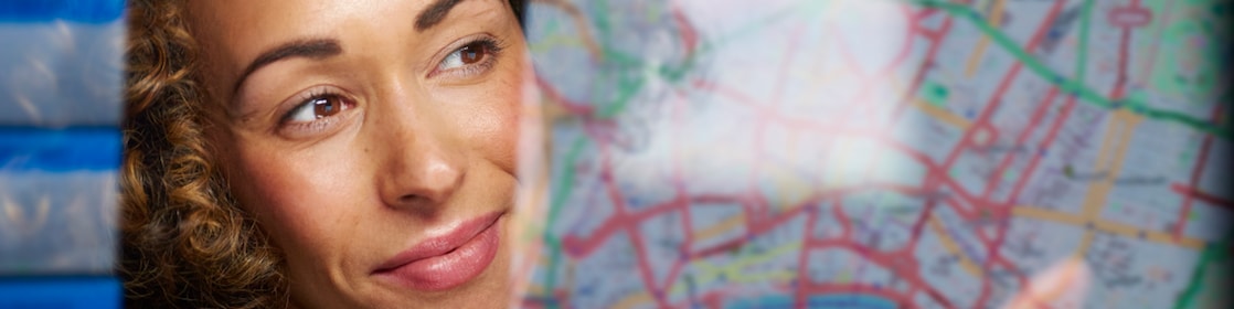 Woman wearing microphone pointing on map