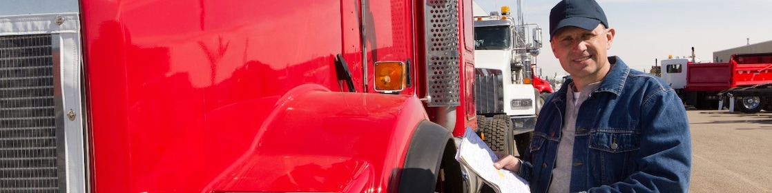 Man standing near truck with file in hand