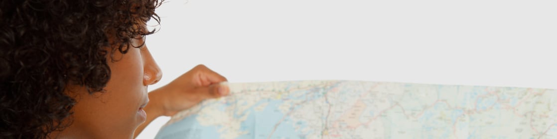 Woman holding a map looking for specific location