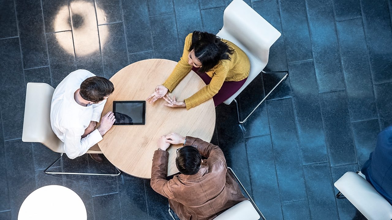 Team of Polymer Experts talking around a table