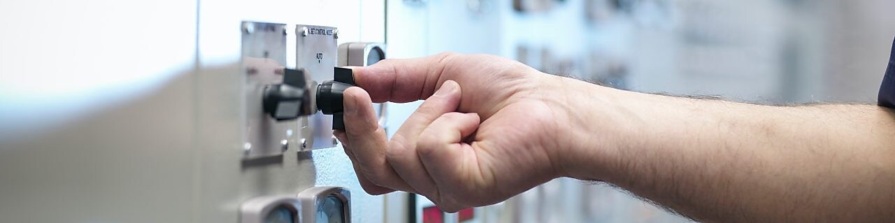 Production operator pressing a button on the control panel