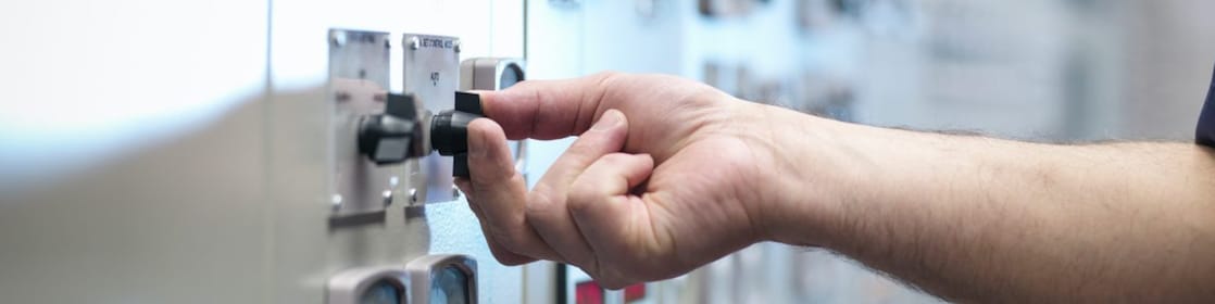 Production operator pressing a button on the control panel