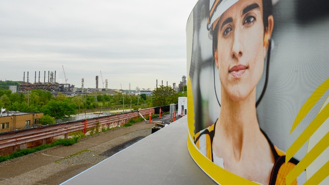 Road viwe and female face banner on vehicle