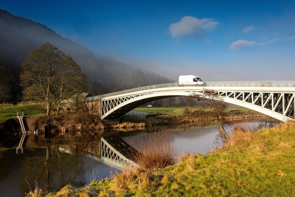 Commercial van crossing bridge