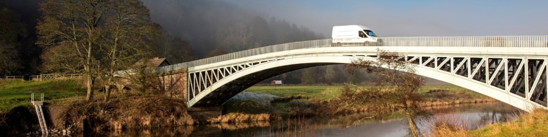 Commercial van crossing bridge