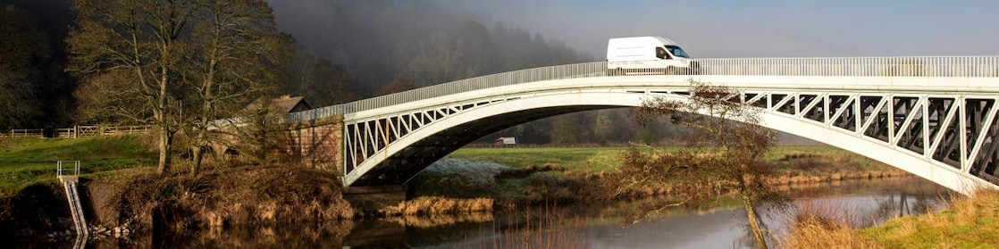 Commercial van crossing bridge