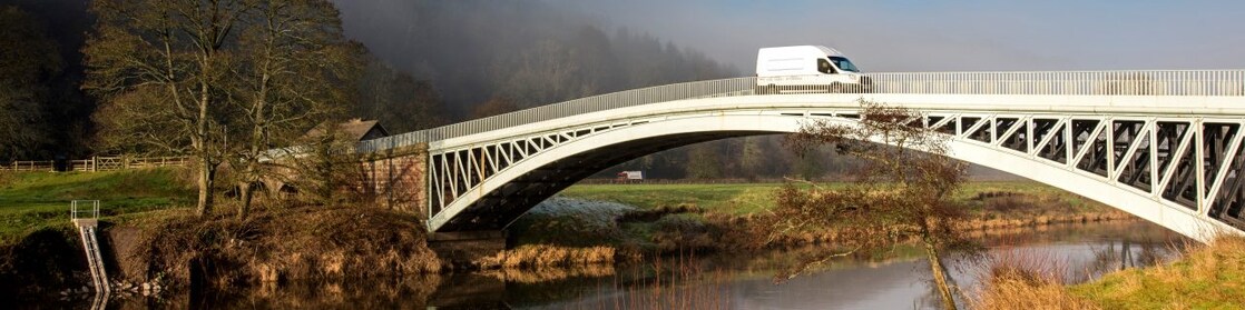 Commercial van crossing bridge