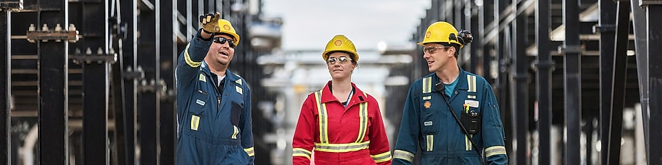 Shell engineers walking together at an operational site