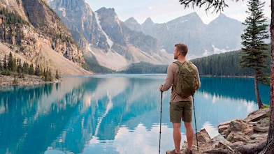 man staring out into the blue mountains