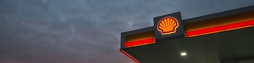 Sunrise through the clouds over a Shell Station