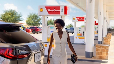 Hand holding Shell fuel rewards mastercard