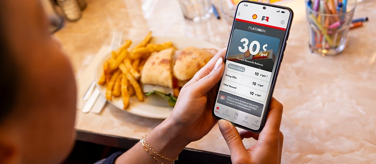 woman and man in restaurant looking at a menu