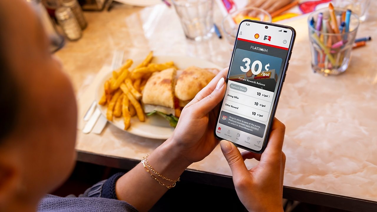 woman and man in restaurant looking at a menu