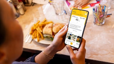 woman and man in restaurant looking at a menu