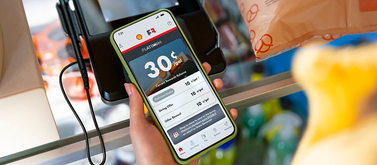 woman looking at FR account while in store