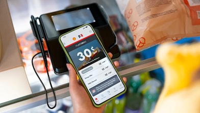 woman looking at FR account while in store