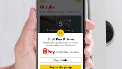Man holding a phone with s pay app